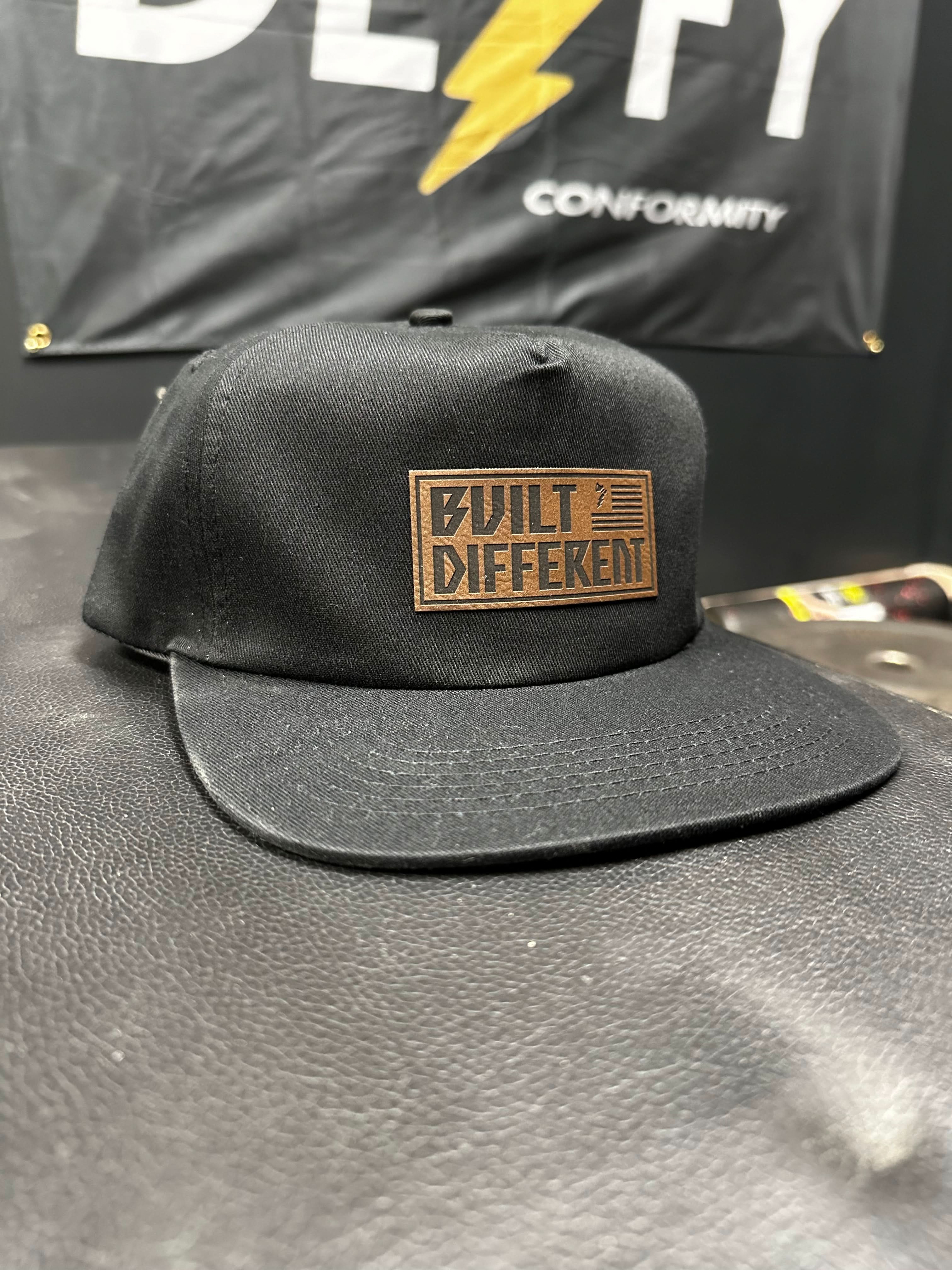 Built Different Patch Snapback Hat - We Defy The Norm