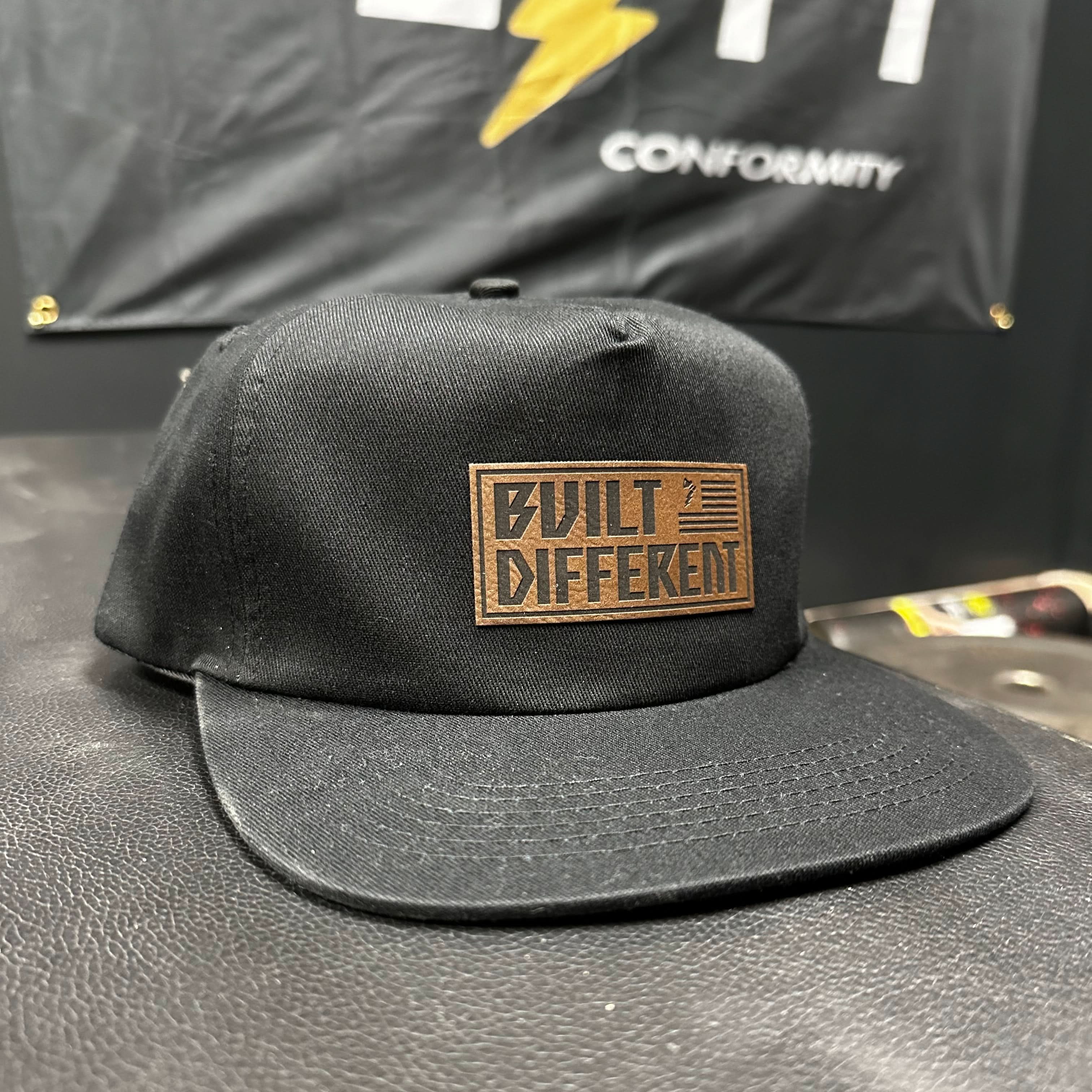 Built Different Patch Snapback Hat - We Defy The Norm